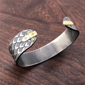 Snake cuff with yellow sapphires